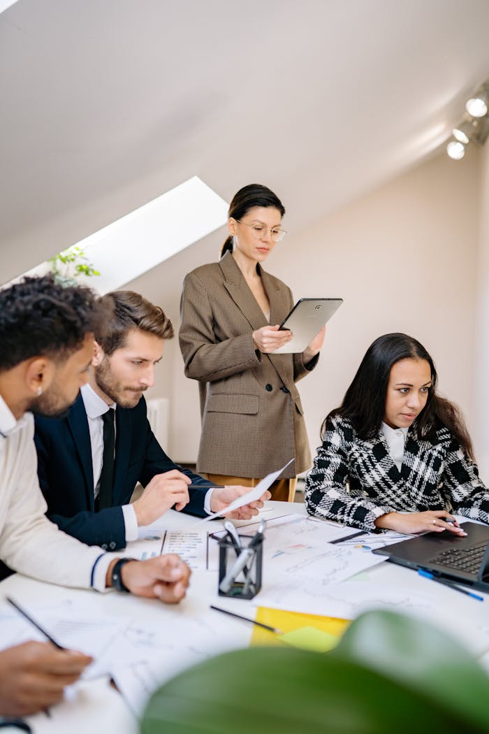 about-02 A diverse team working together in a bright office space, collaborating on a project.